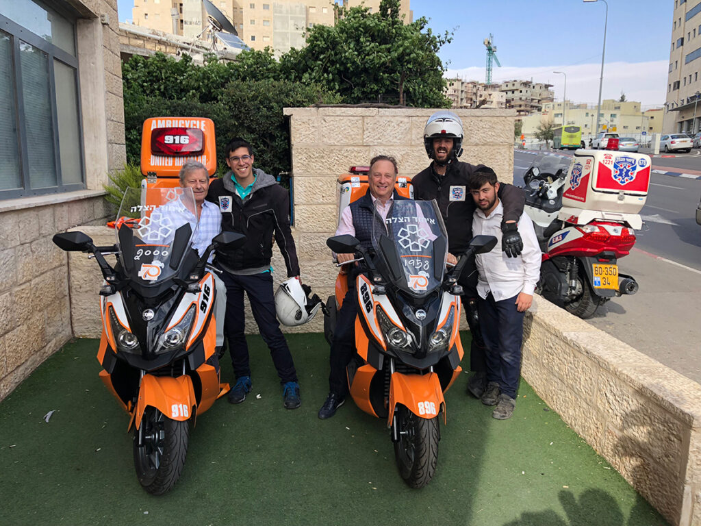 Miles Nadal (Center – Seated) on one of the ambucycles he donated to United Hatzalah of Israel